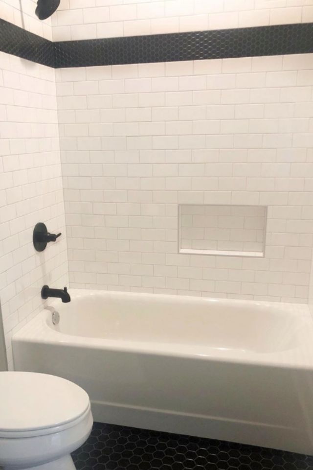 White subway tile shower in bathroom shower with black tile accent