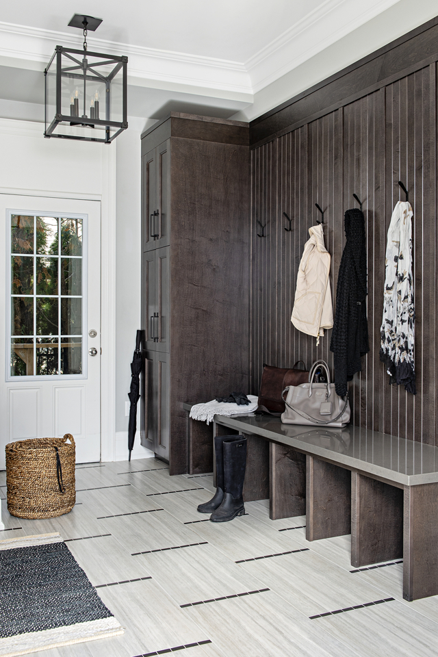 Entryway with box storage and hooks for jackets with tile